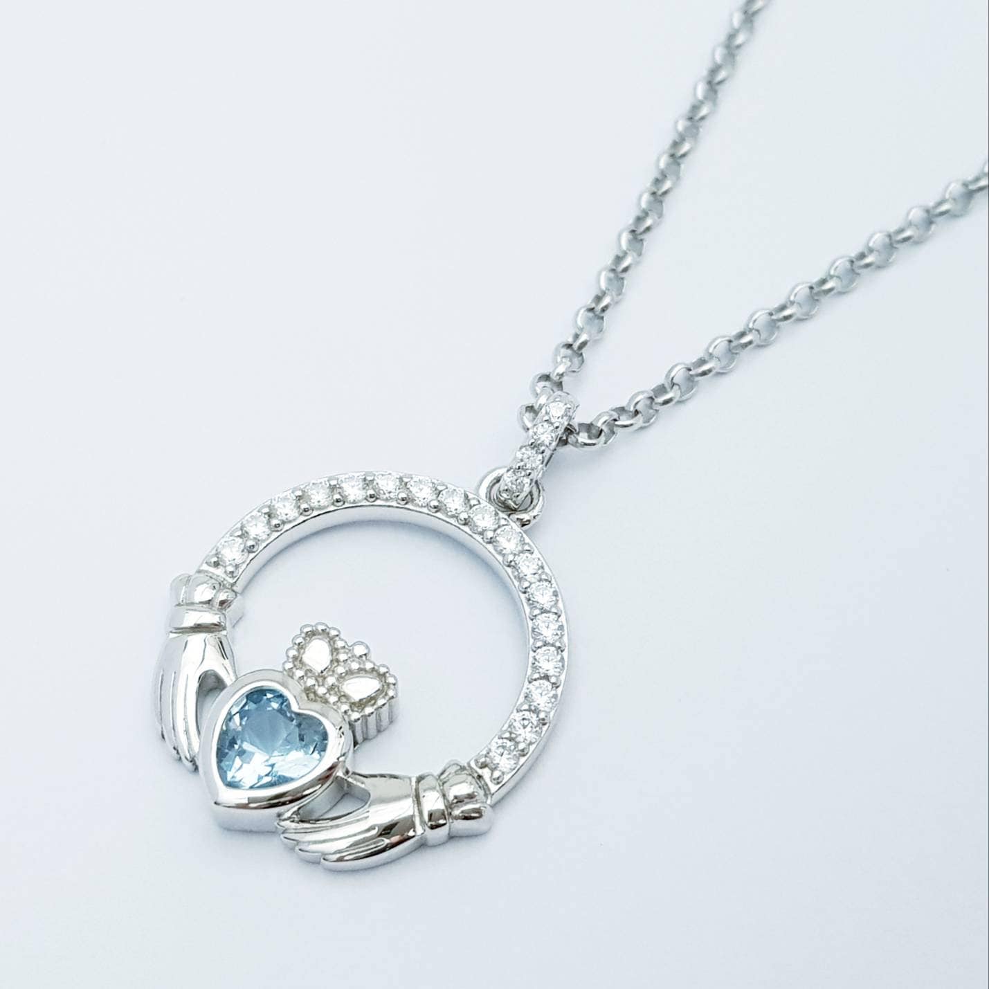Sterling silver claddagh necklace with light blue aquamarine heart shaped stone, march birthstone