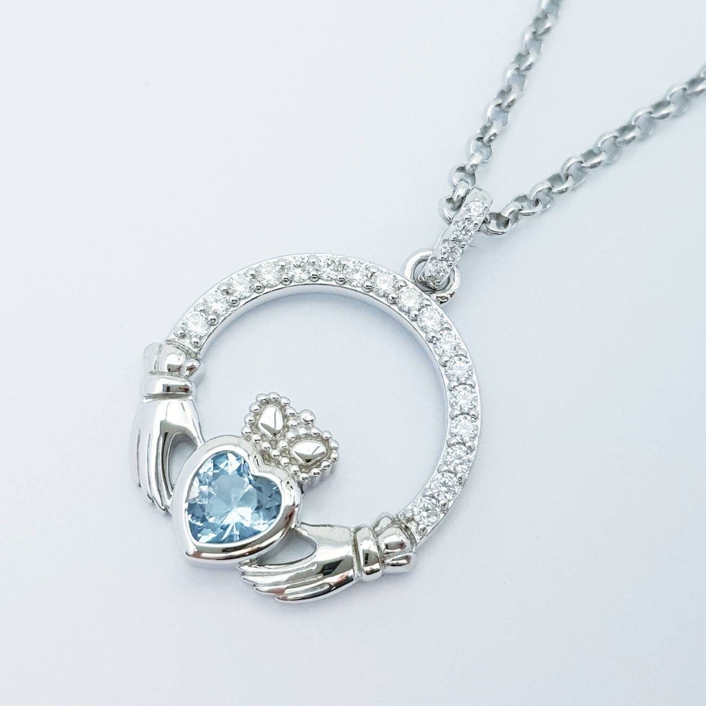 Sterling silver claddagh necklace with light blue aquamarine heart shaped stone, march birthstone