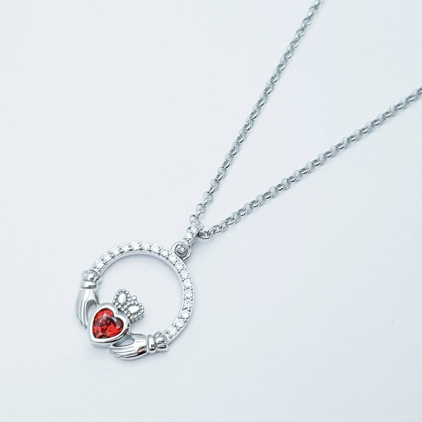 Sterling silver claddagh necklace with red garnet heart shaped stone, January birthstone