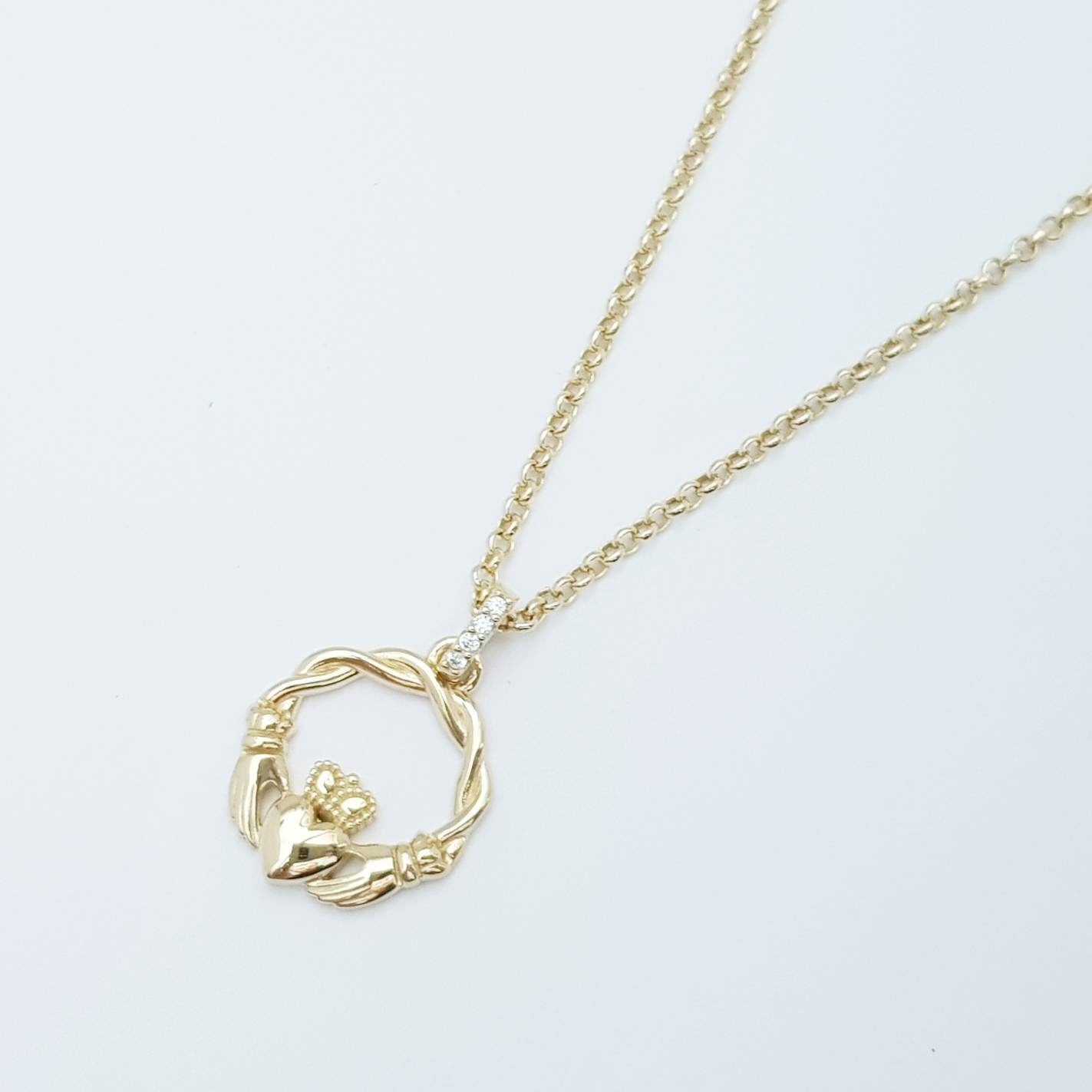 Dainty Sterling Silver claddagh necklace with gold plating and intertwined celtic braid.