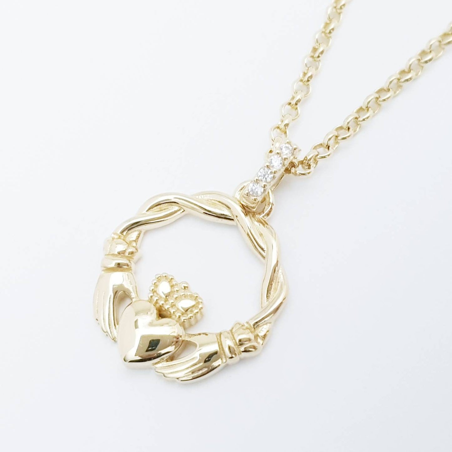 Dainty Sterling Silver claddagh necklace with gold plating and intertwined celtic braid.
