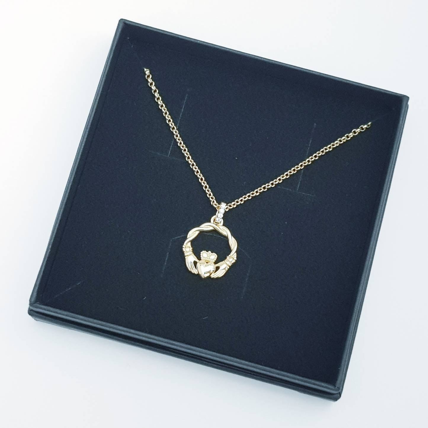 Dainty Sterling Silver claddagh necklace with gold plating and intertwined celtic braid.
