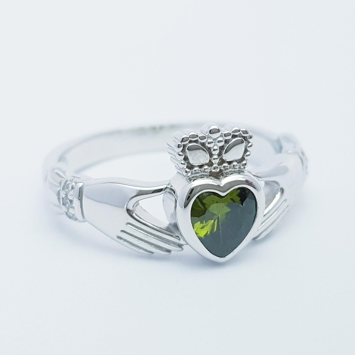 Irish Claddagh ring set with green peridot heart shaped stone from Galway, Ireland