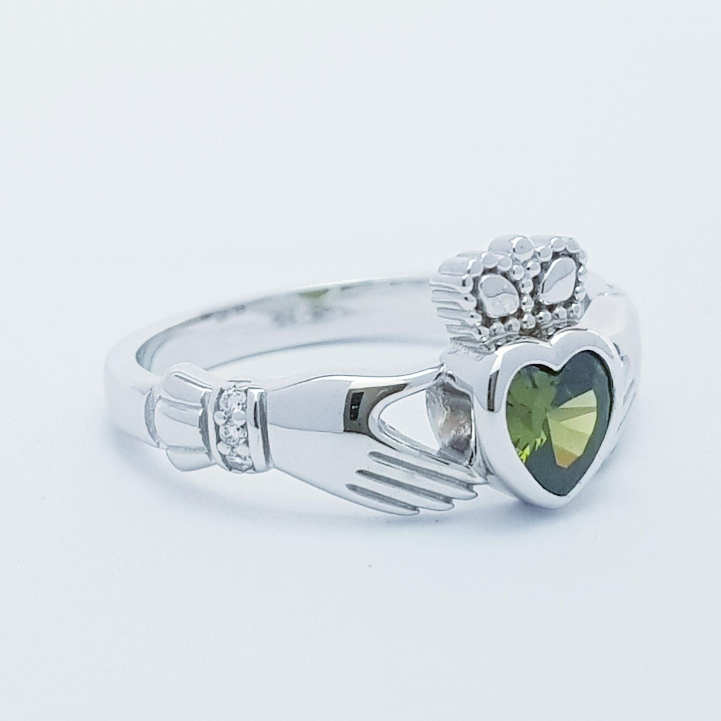 Irish Claddagh ring set with green peridot heart shaped stone from Galway, Ireland
