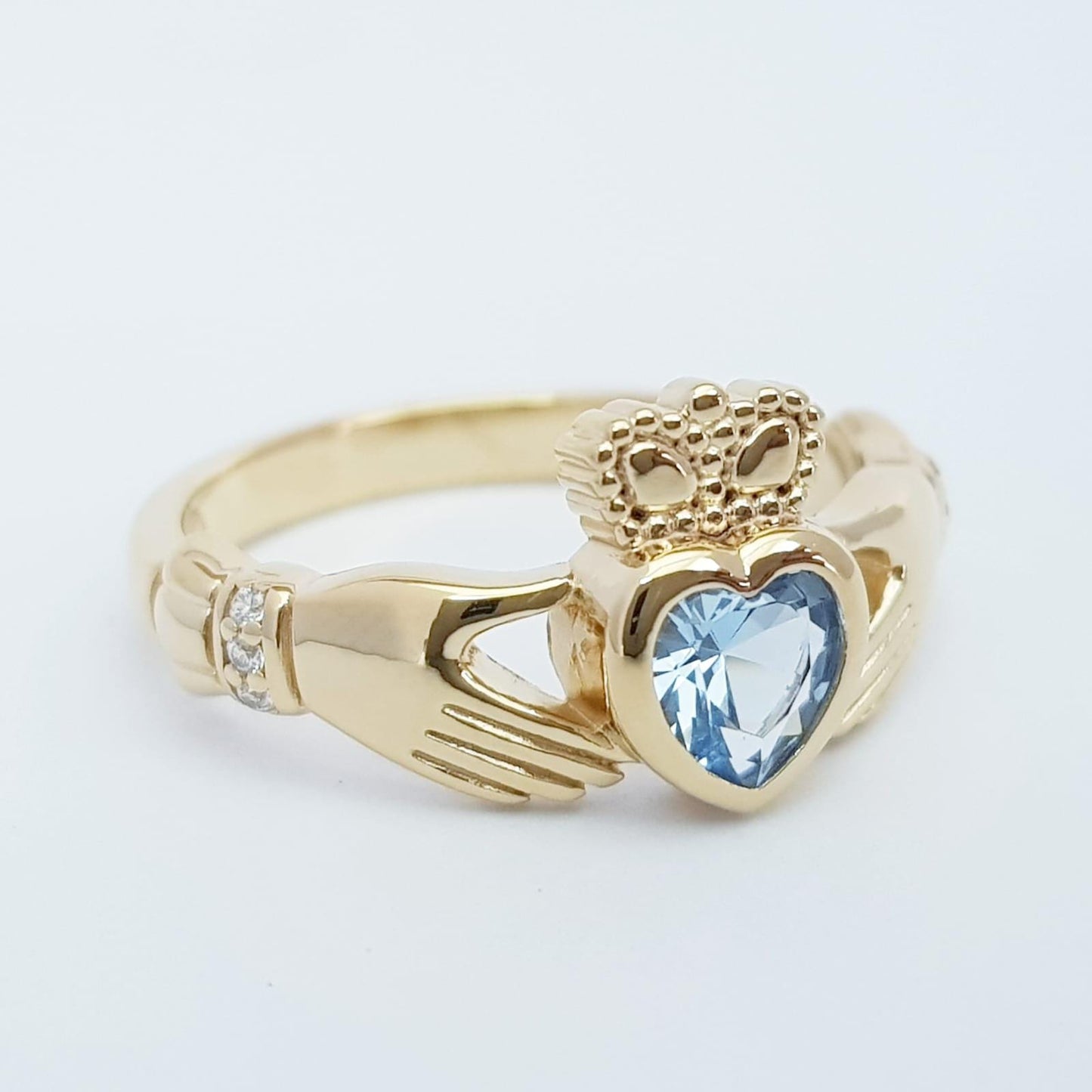 Sterling Silver Yellow Gold plated Claddagh ring set with aquamarine heart shaped stone, may birthstone claddagh ring from Ireland