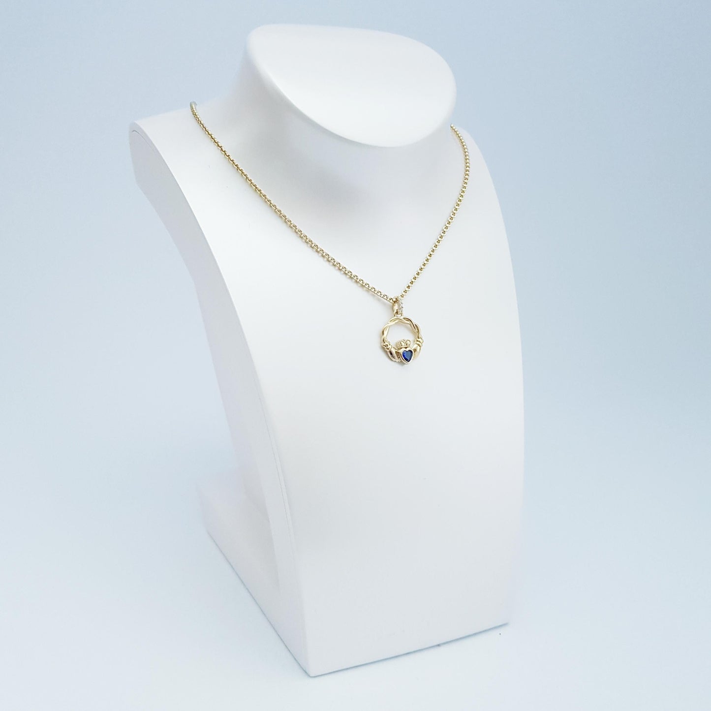 Dainty Sterling Silver claddagh necklace set with blue September birthstone