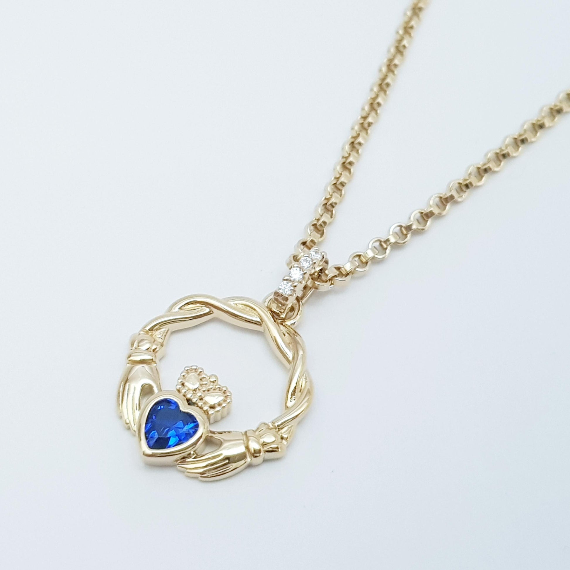 Dainty Sterling Silver claddagh necklace set with blue September birthstone