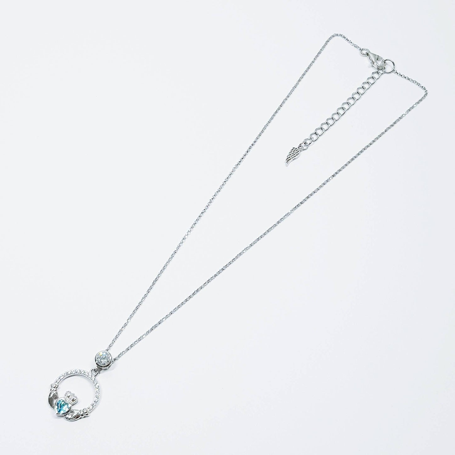 Sterling silver claddagh necklace set with electric blue December birthstone from Ireland