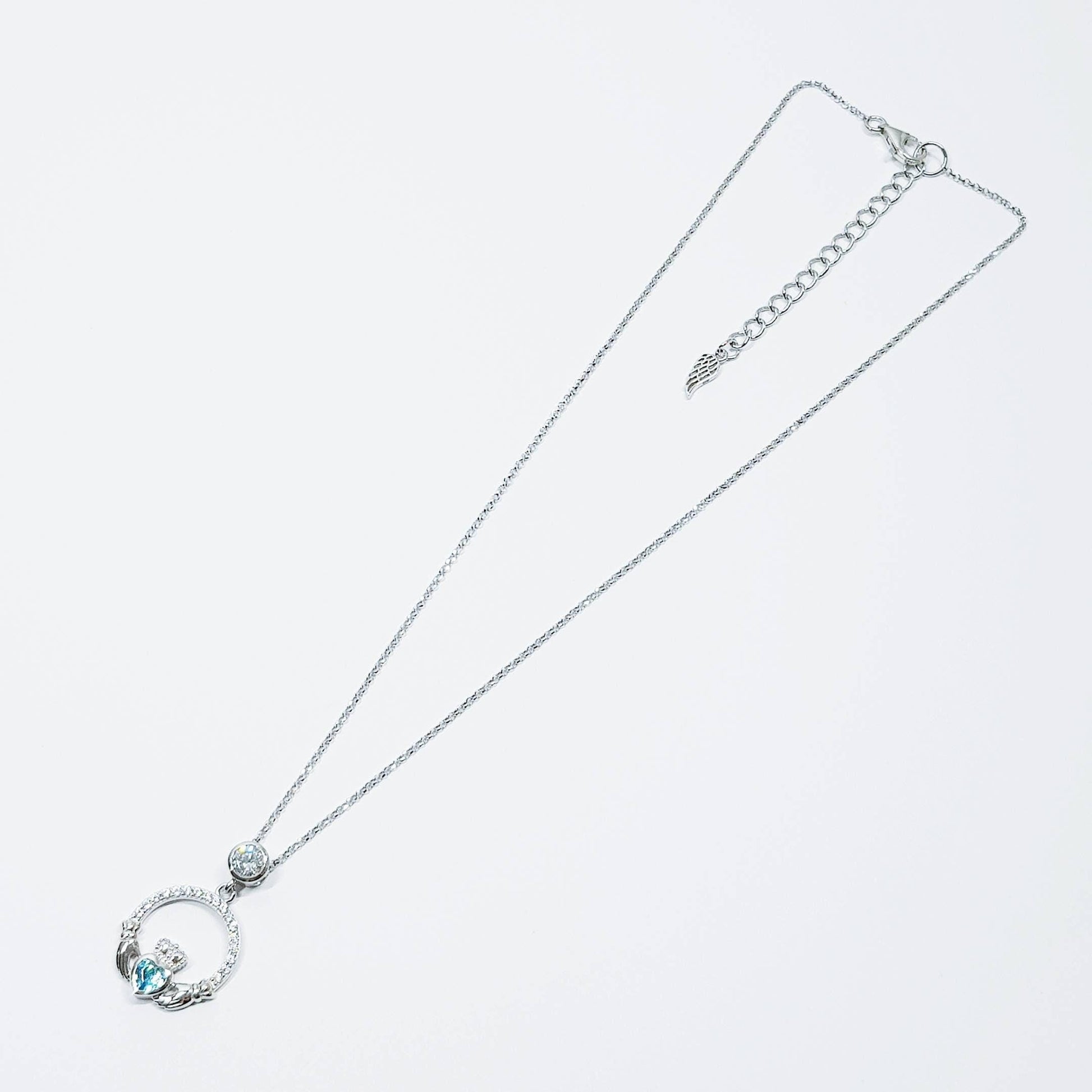 Sterling silver claddagh necklace set with electric blue December birthstone from Ireland