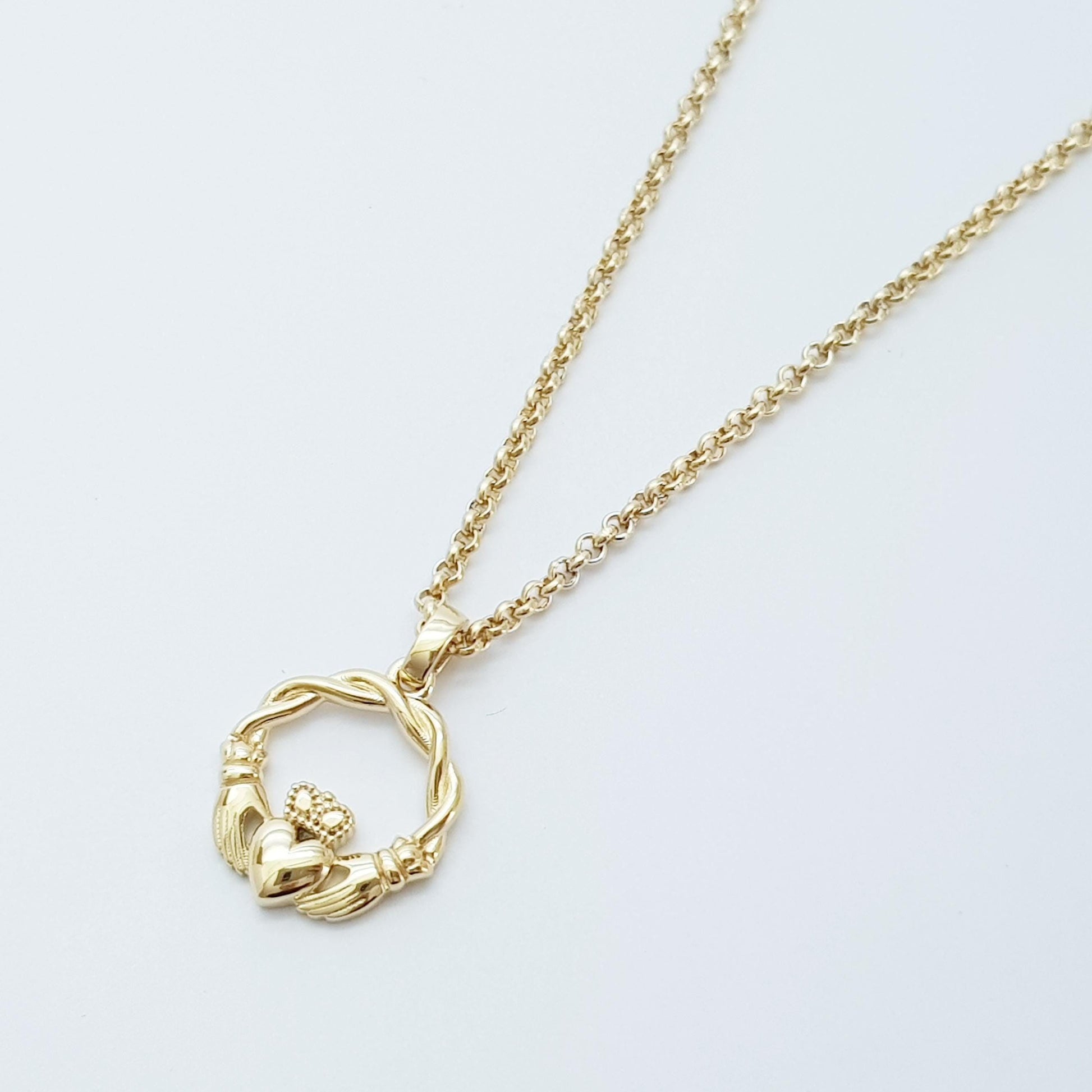 Small Sterling Silver claddagh necklace with gold plating and celtic braid.