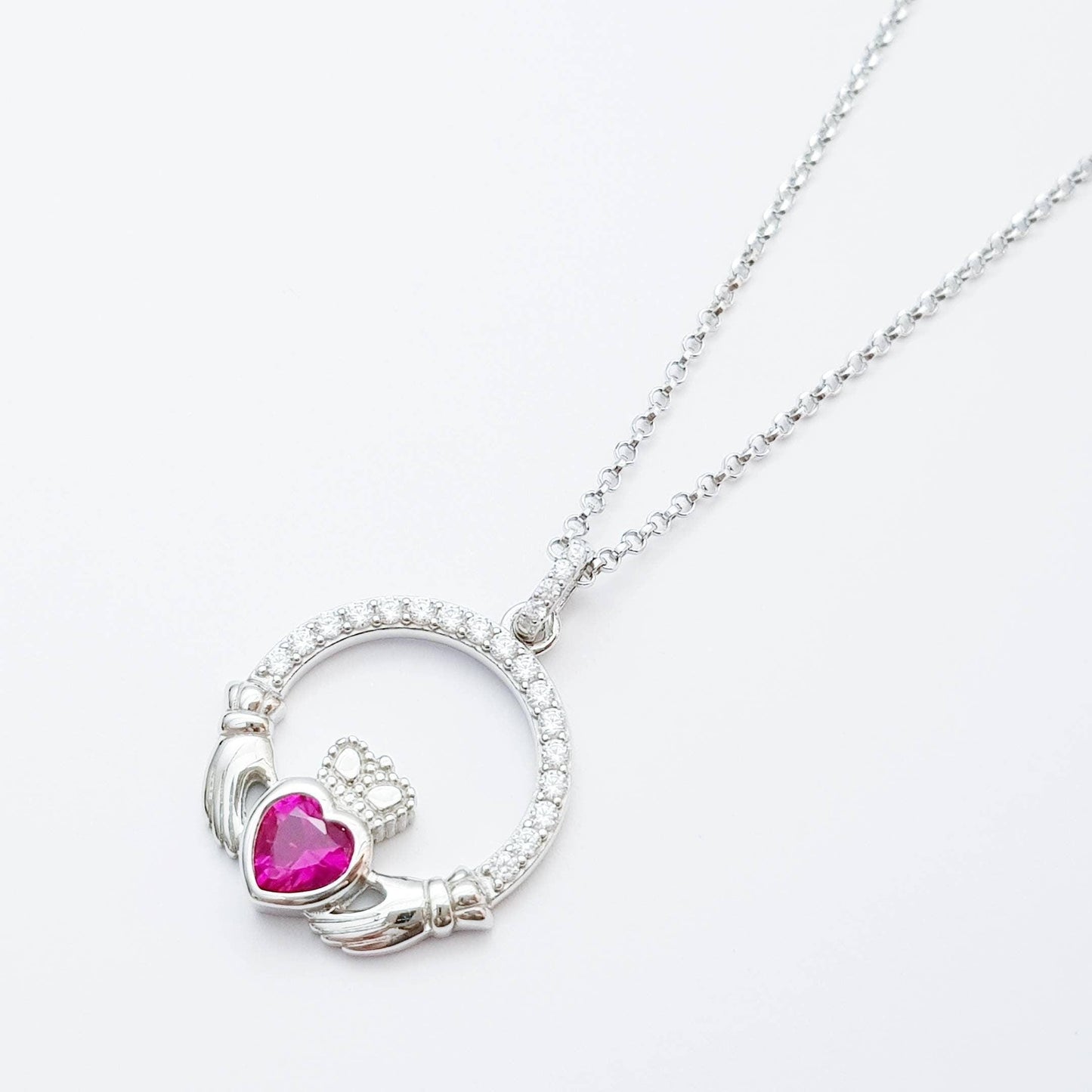 Sterling silver claddagh necklace set with ruby red July birthstone from Ireland
