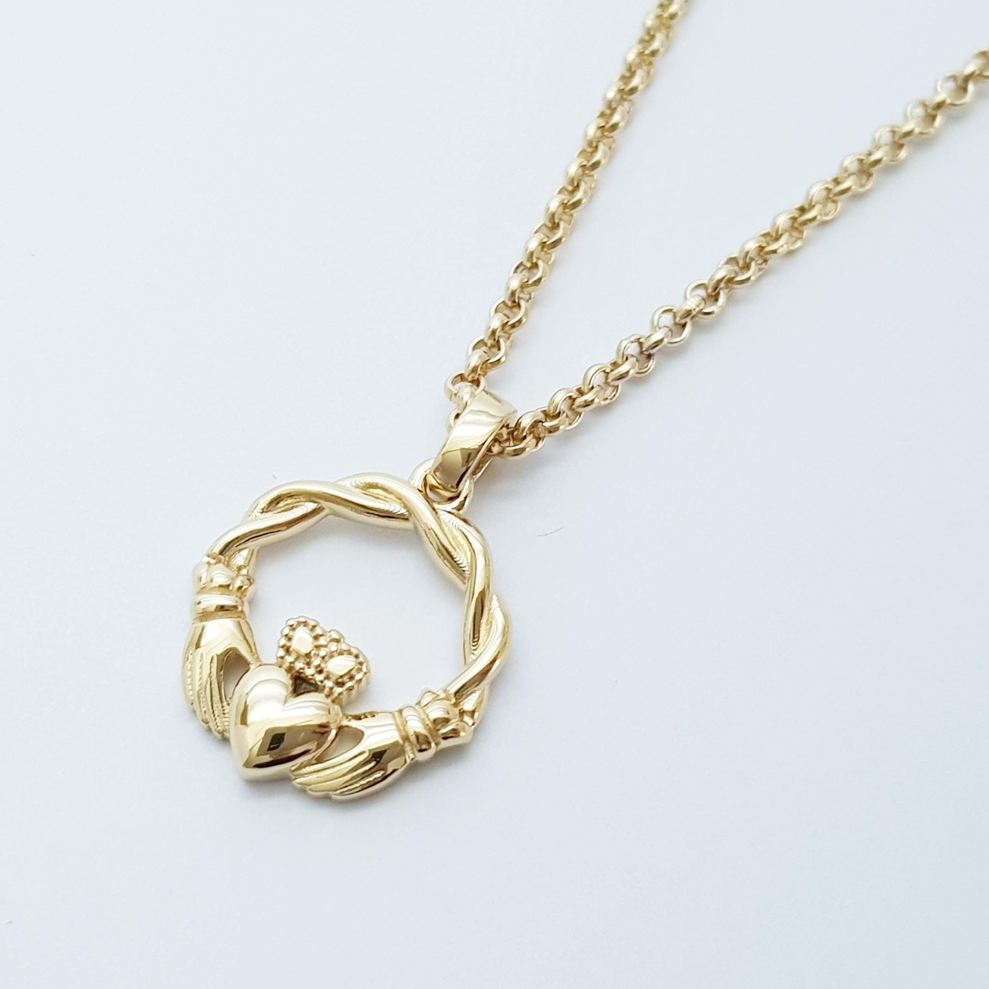 Small Sterling Silver claddagh necklace with gold plating and celtic braid.