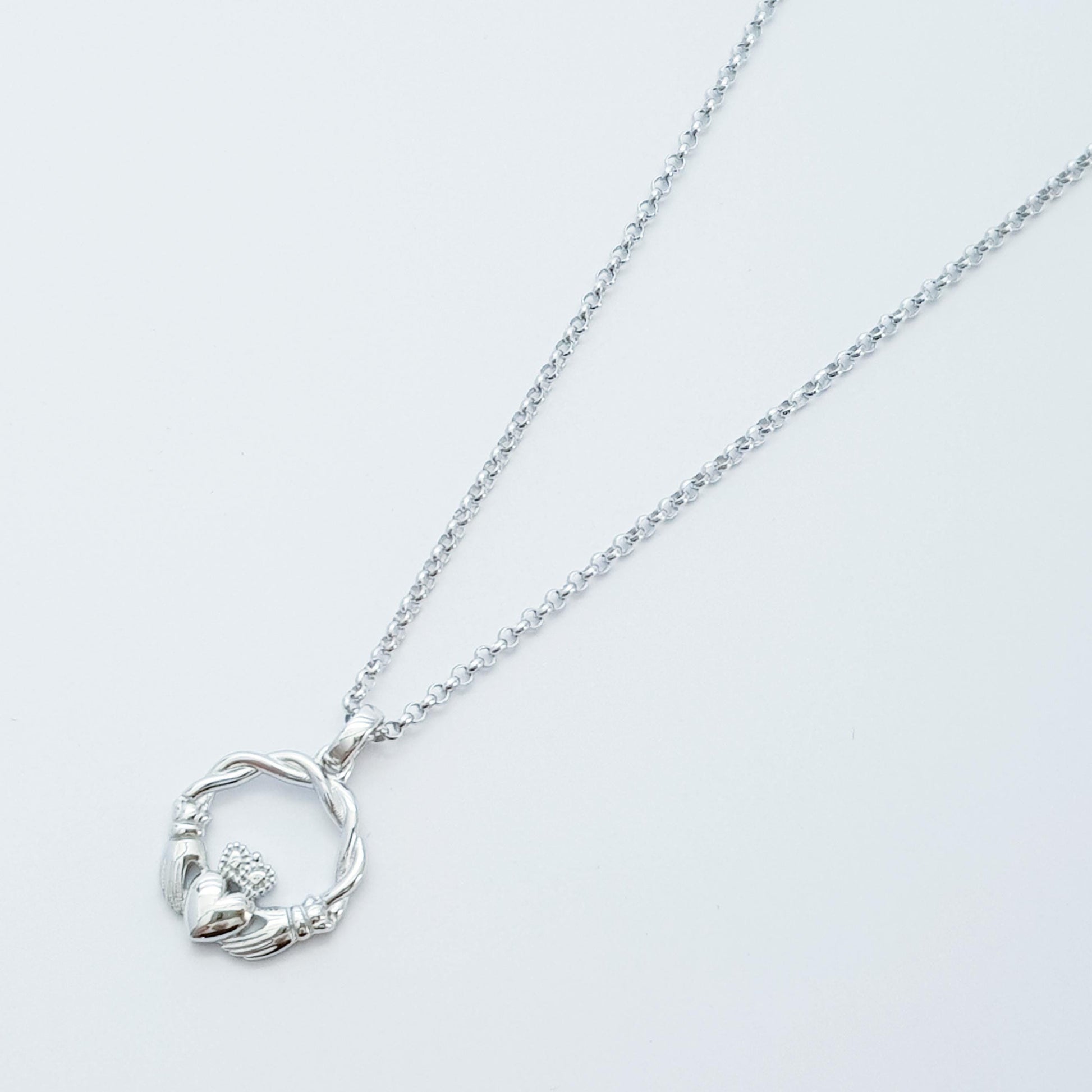 Small Sterling Silver claddagh necklace with gold plating and celtic braid.