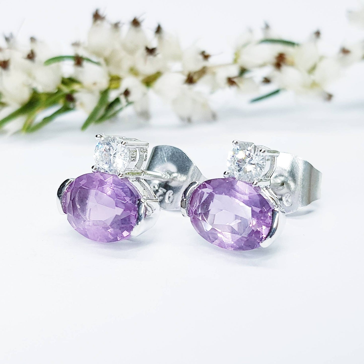 Small sterling silver studs set with purple and white cubic zirconia, sideways oval amethyst