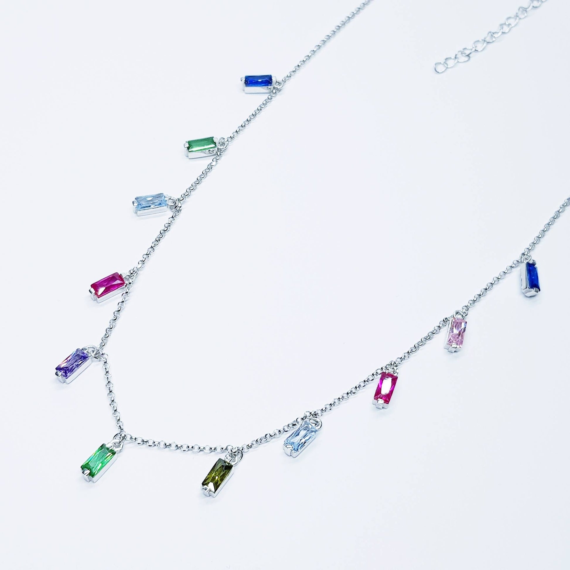 Sterling silver rainbow necklace with multi coloured stones dangling along the neckline
