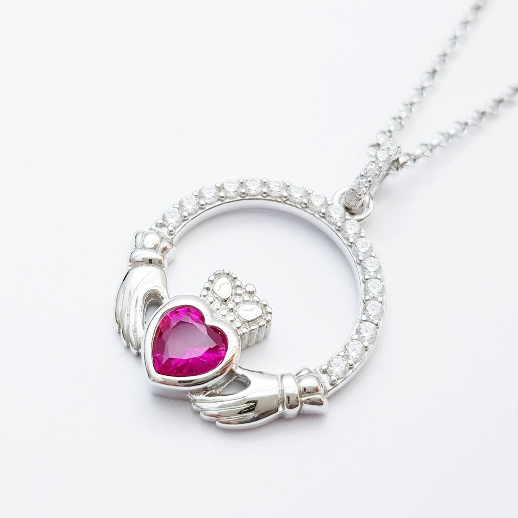 Sterling silver claddagh necklace set with ruby red July birthstone from Ireland