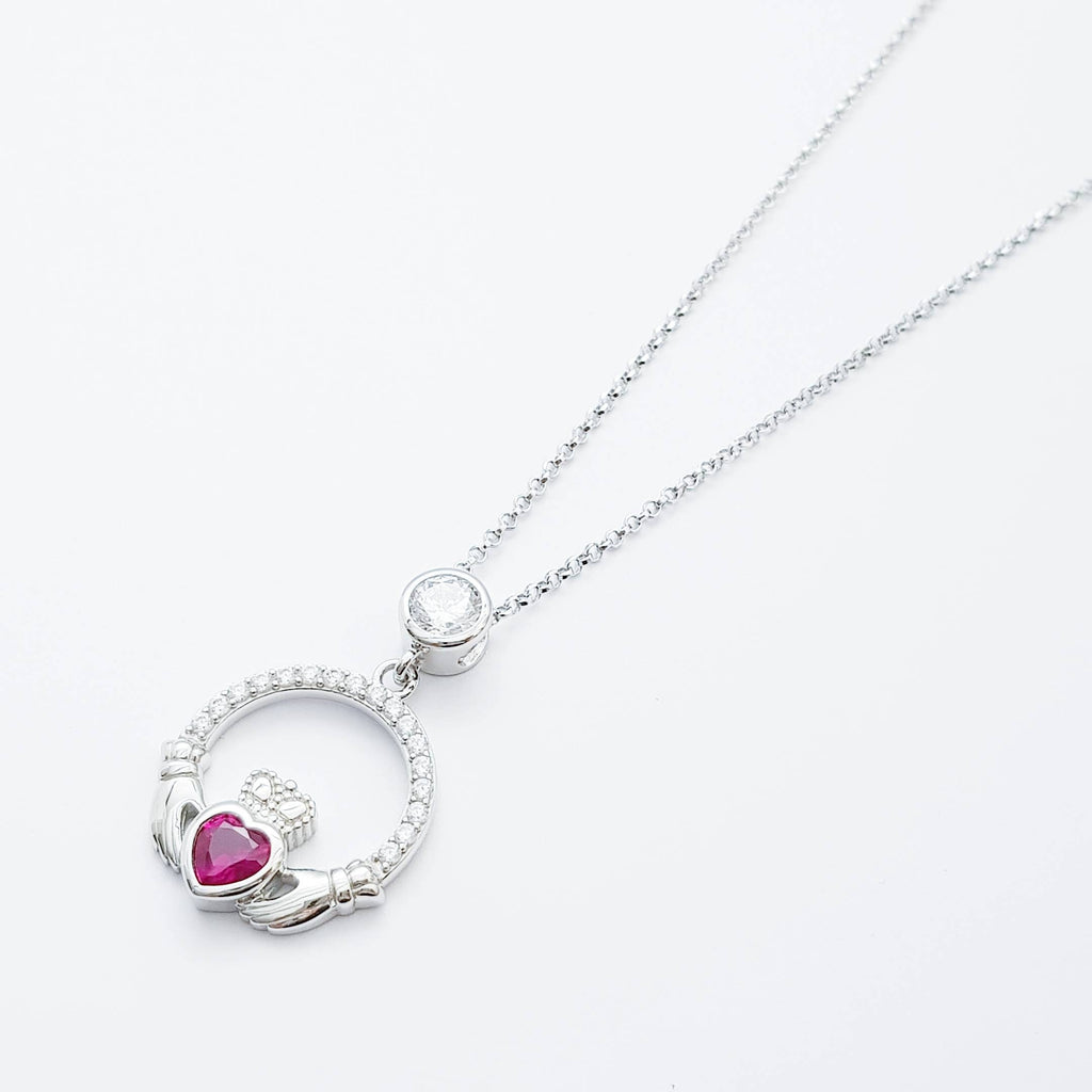 Sterling silver claddagh necklace set with ruby red July birthstone from Ireland
