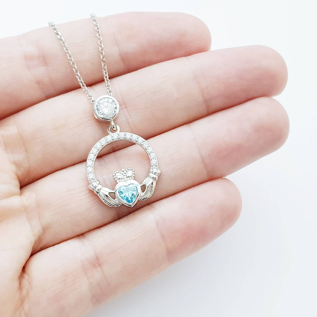 Sterling silver claddagh necklace set with electric blue December birthstone from Ireland