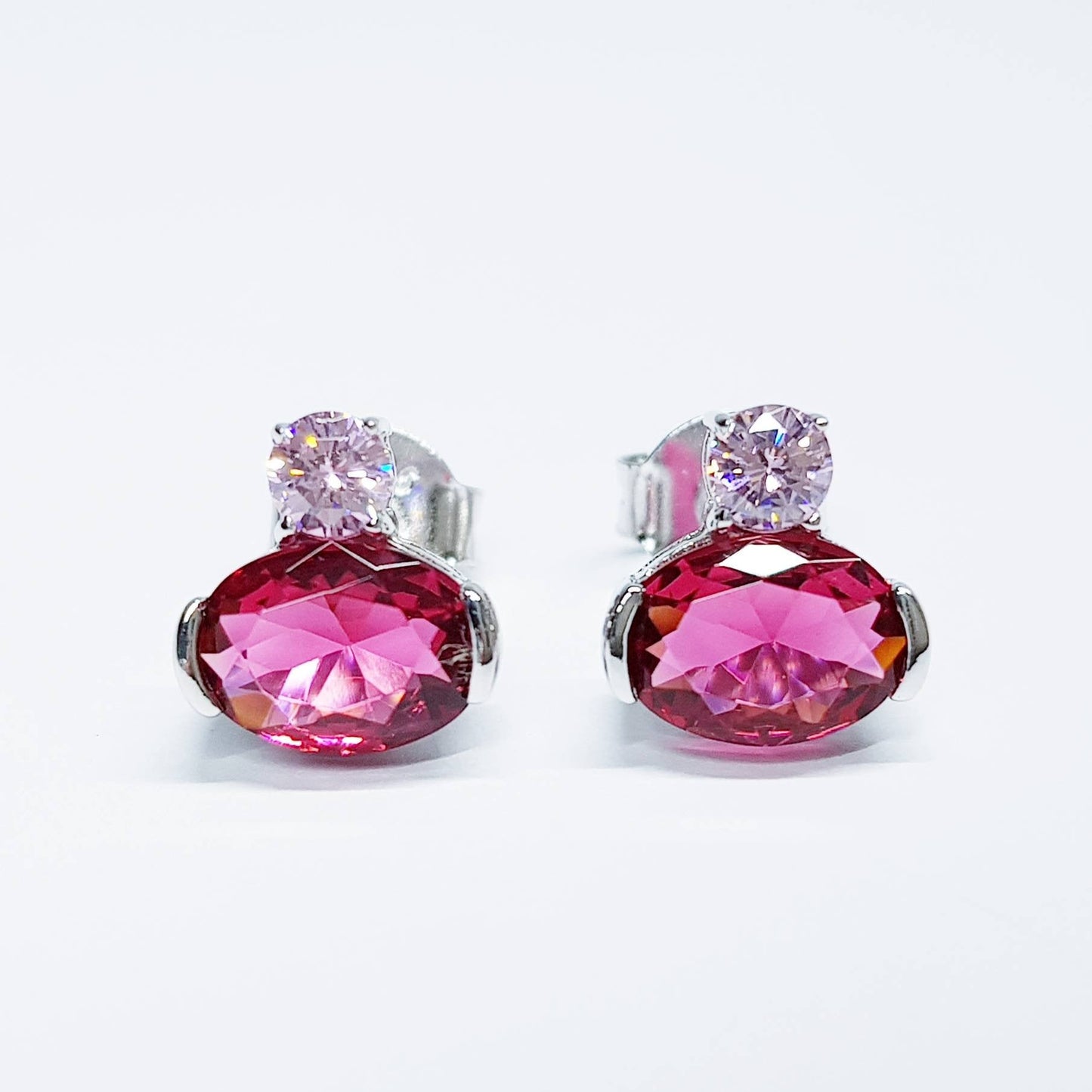 Sterling silver studs set with ruby red and pink cubic zirconia