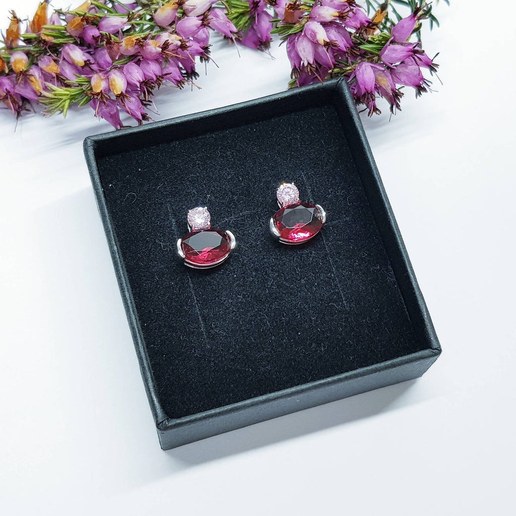 Sterling silver studs set with ruby red and pink cubic zirconia