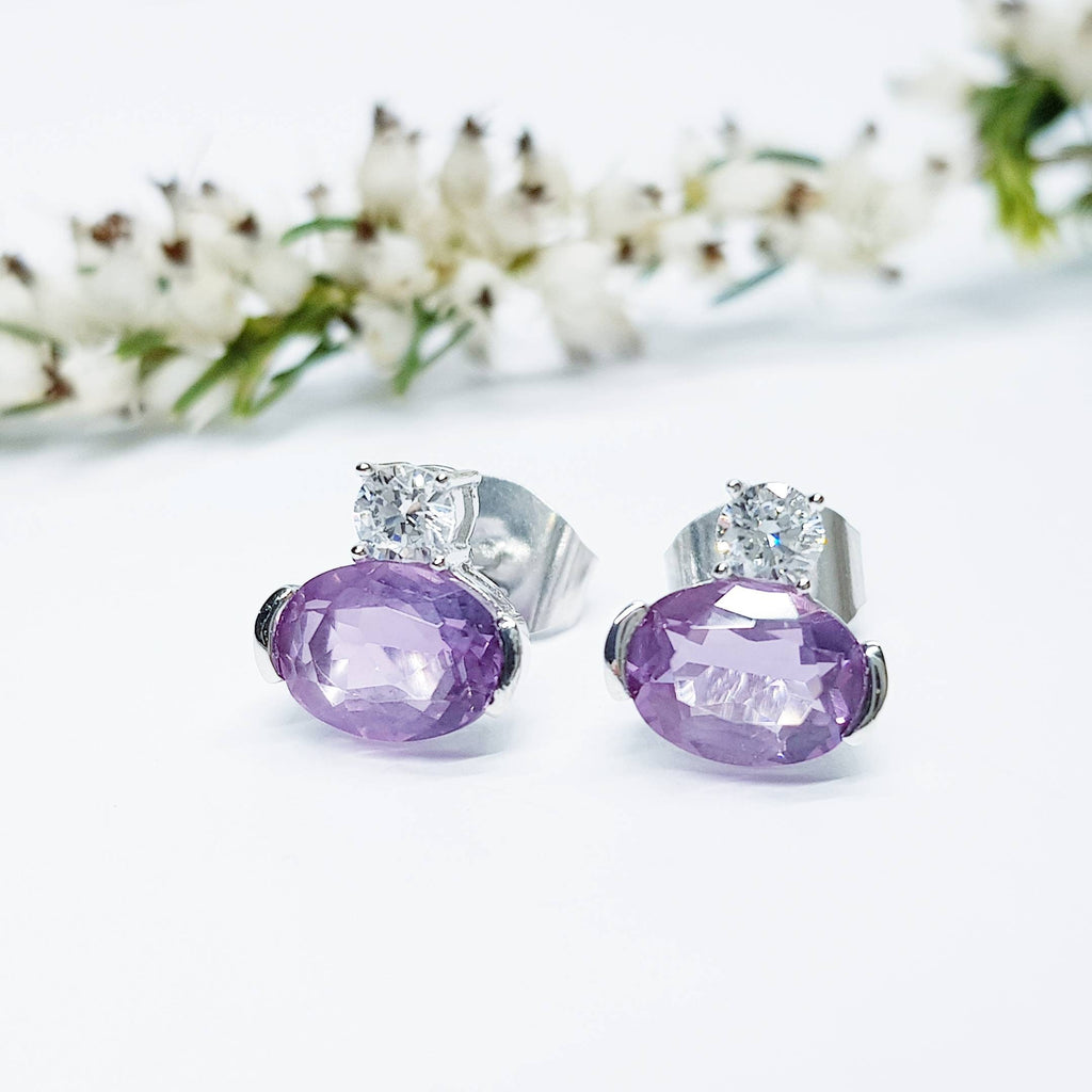 Small sterling silver studs set with purple and white cubic zirconia, sideways oval amethyst