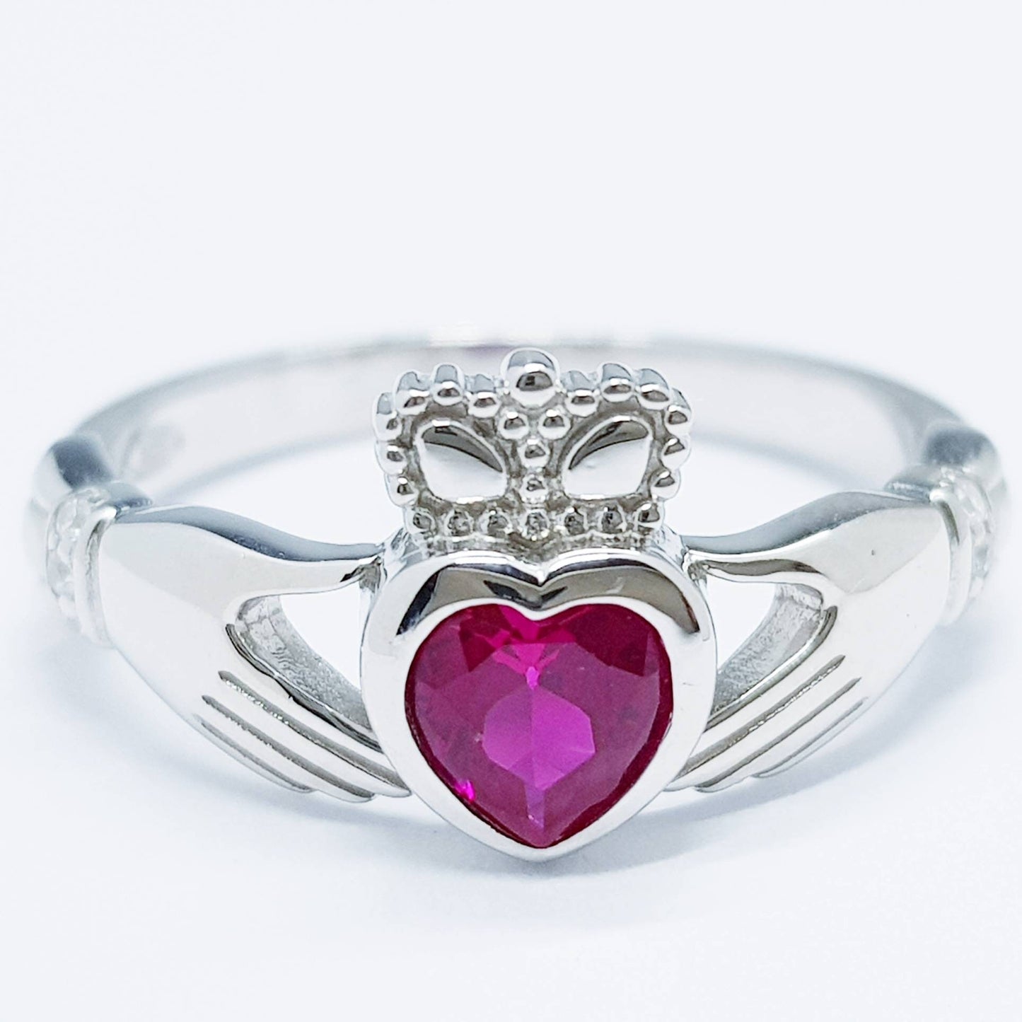 Sterling Silver Claddagh ring set with ruby red heart shaped stone, July birthstone claddagh ring