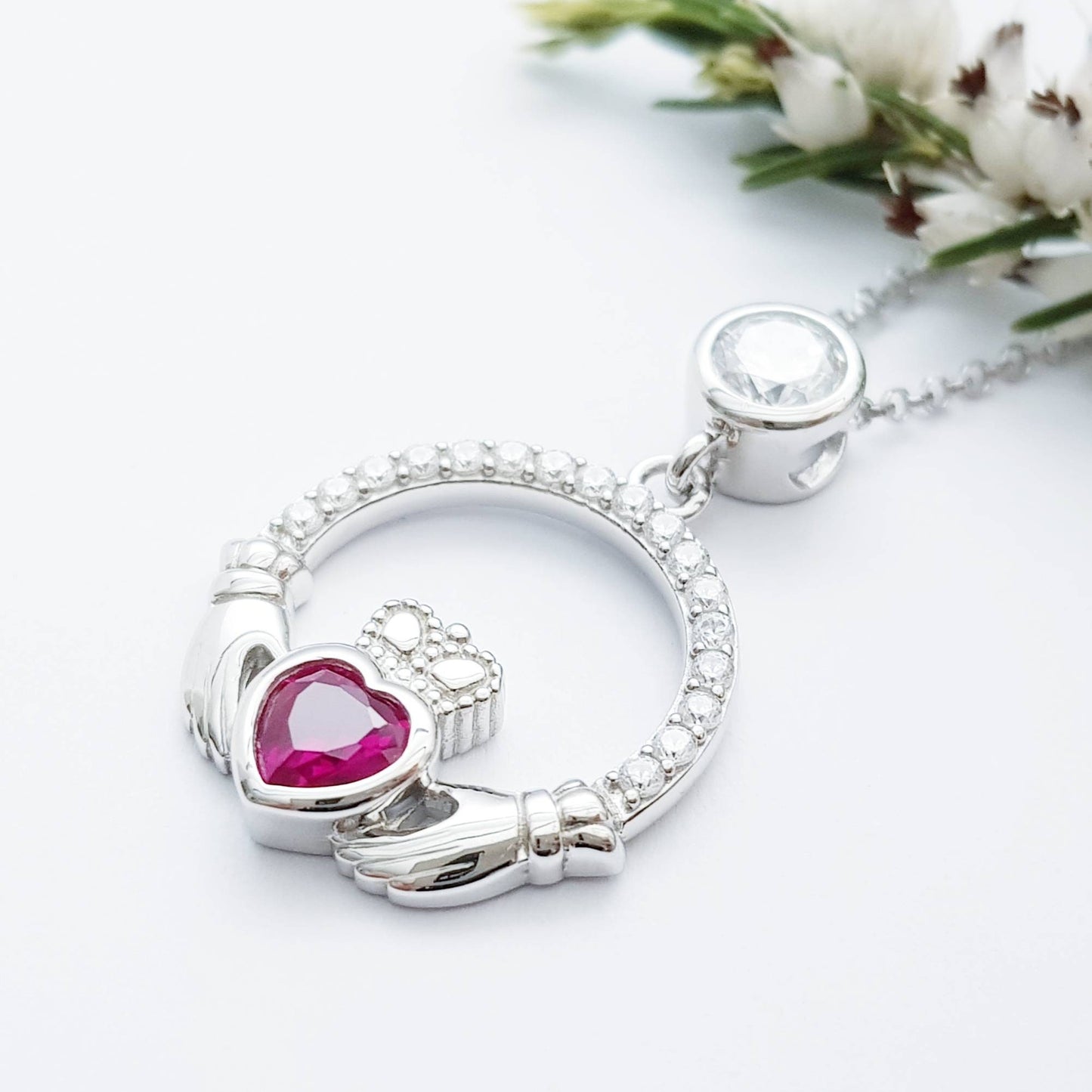 Sterling silver claddagh necklace set with ruby red July birthstone from Ireland
