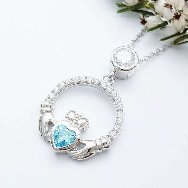 Sterling silver claddagh necklace set with electric blue December birthstone from Ireland