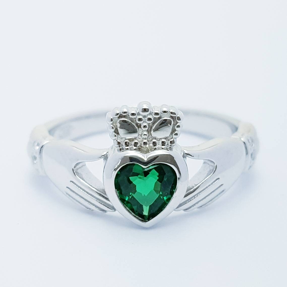 Sterling Silver Claddagh ring set with emerald green heart shaped stone, may birthstone claddagh ring from Ireland