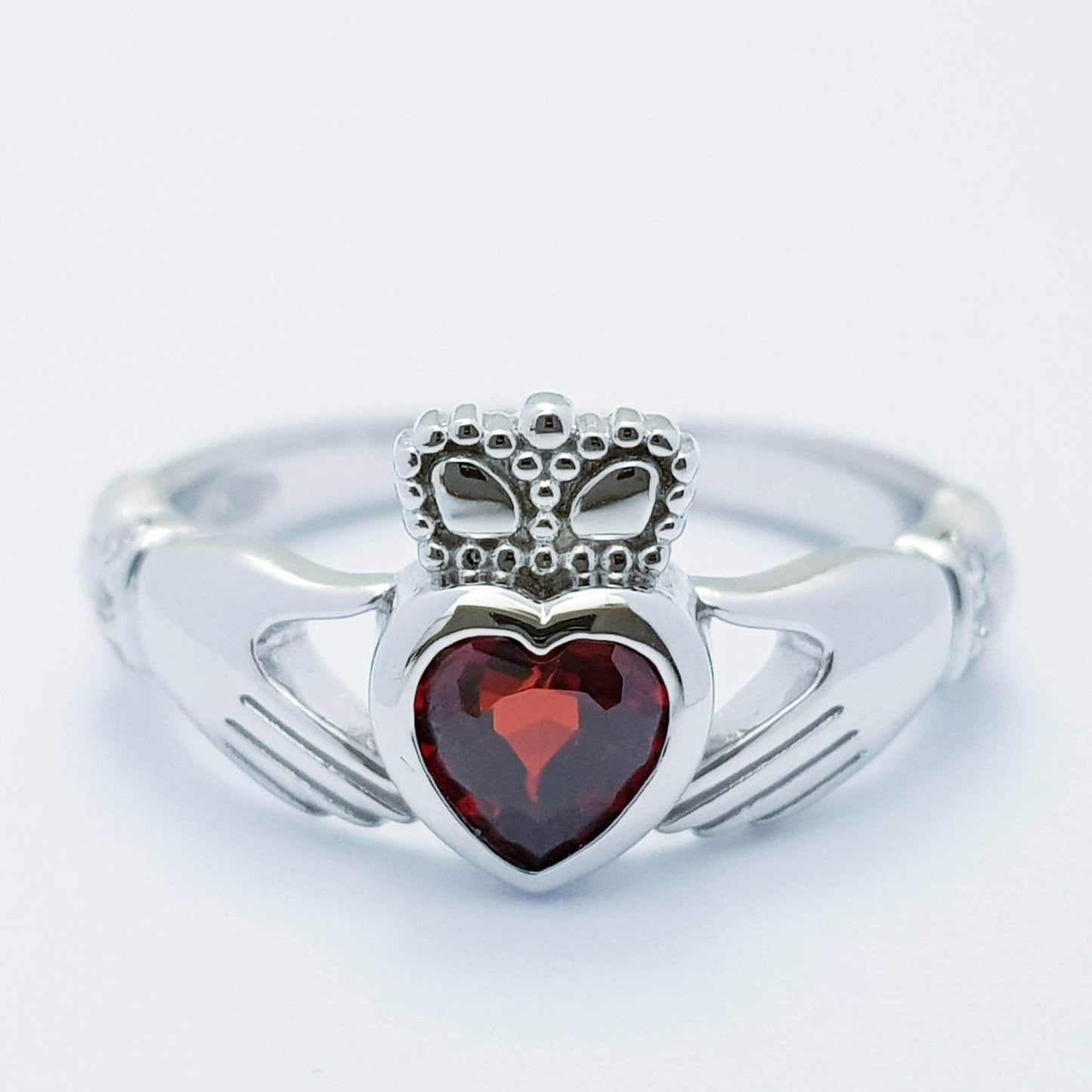 Sterling Silver Claddagh ring set with red garnet heart shaped stone, Irish claddagh rings