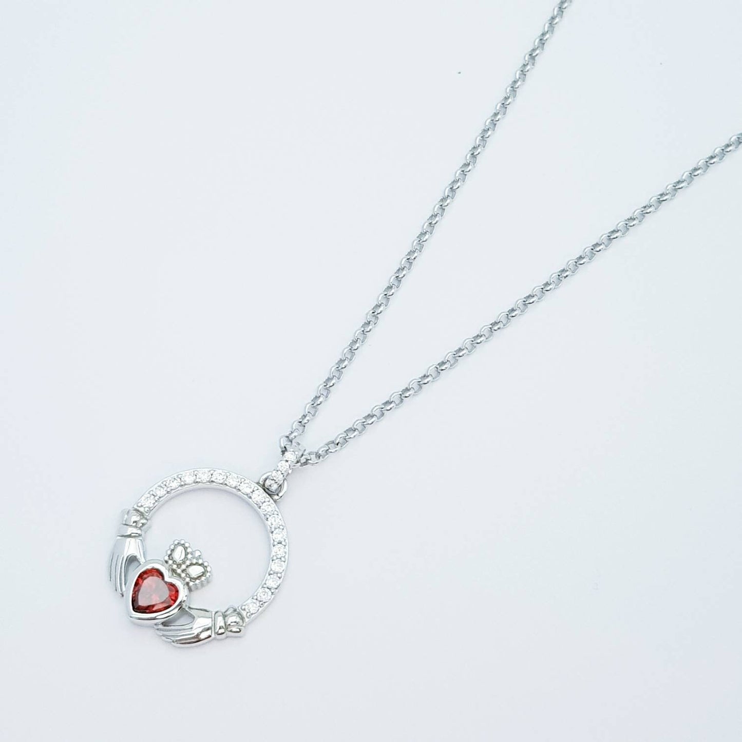 Sterling silver claddagh necklace  with red garnet heart shaped stone, January birthstone
