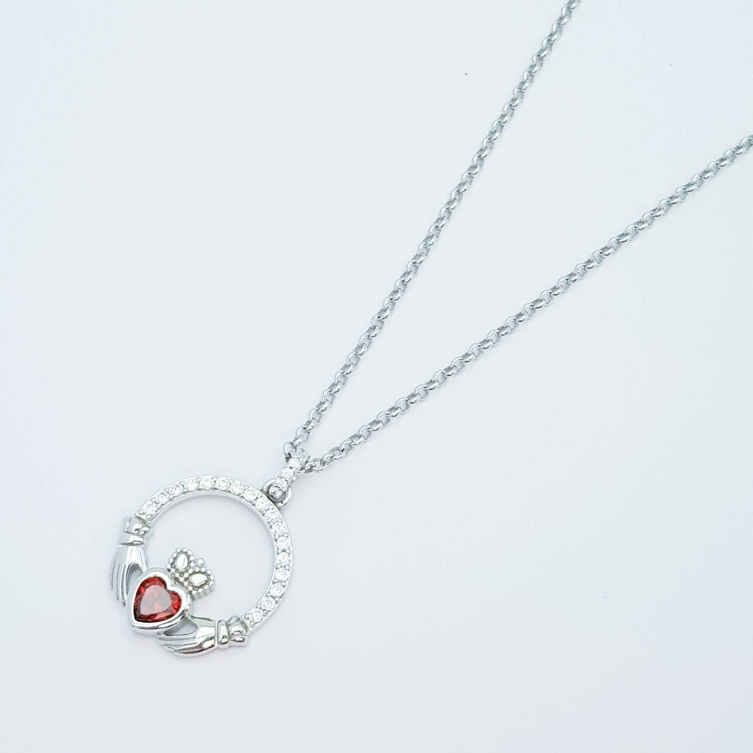 Sterling silver claddagh necklace  with red garnet heart shaped stone, January birthstone