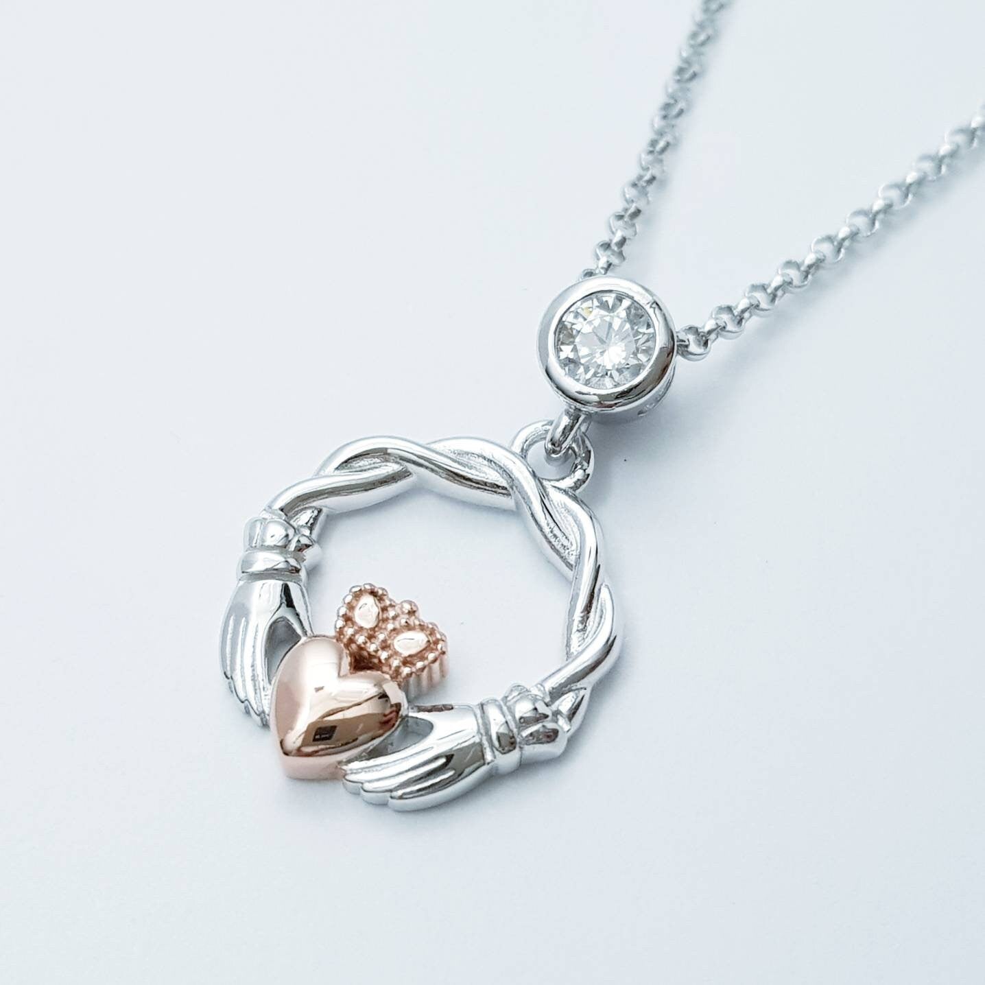 Dainty Sterling Silver claddagh necklace with rose gold plating and intertwined celtic braid.