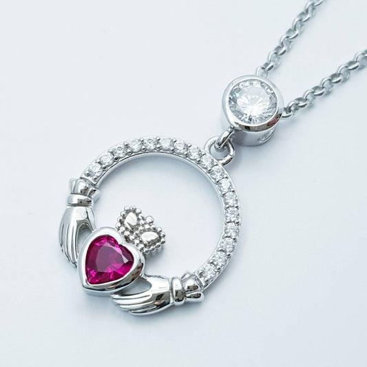 Sterling silver claddagh necklace set with ruby red July birthstone from Ireland