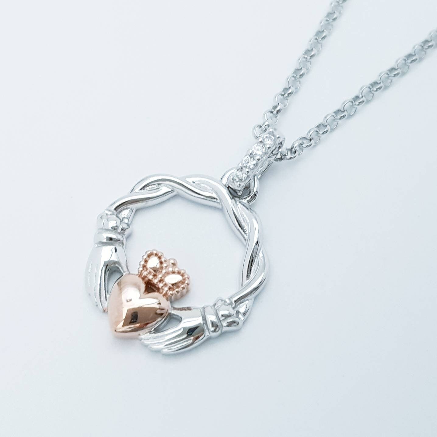 Dainty Sterling Silver claddagh necklace with rose gold plating and intertwined celtic braid.