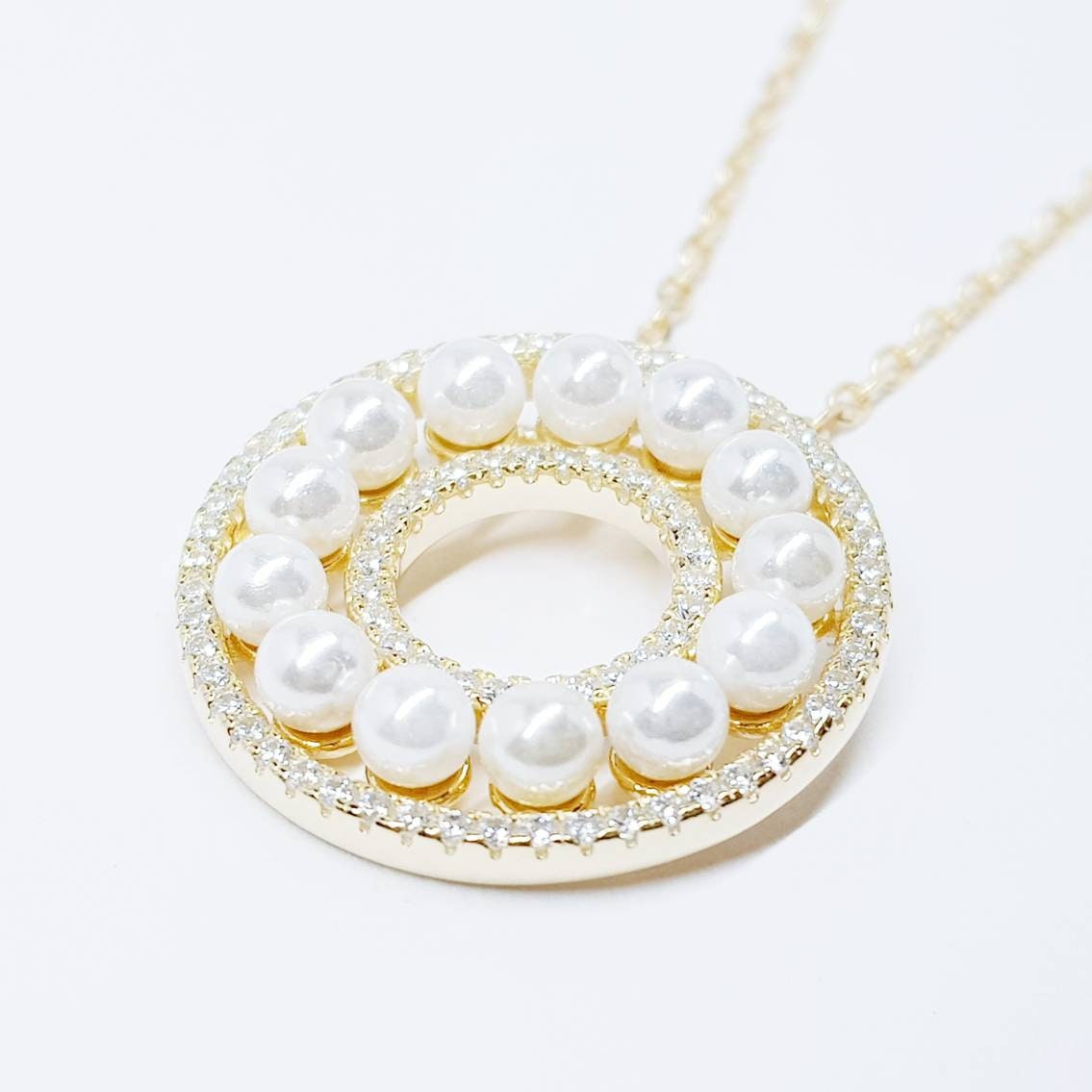 Elegant pearl pendant set in silver with sparkling white cubic zirconia, pearl circle necklace