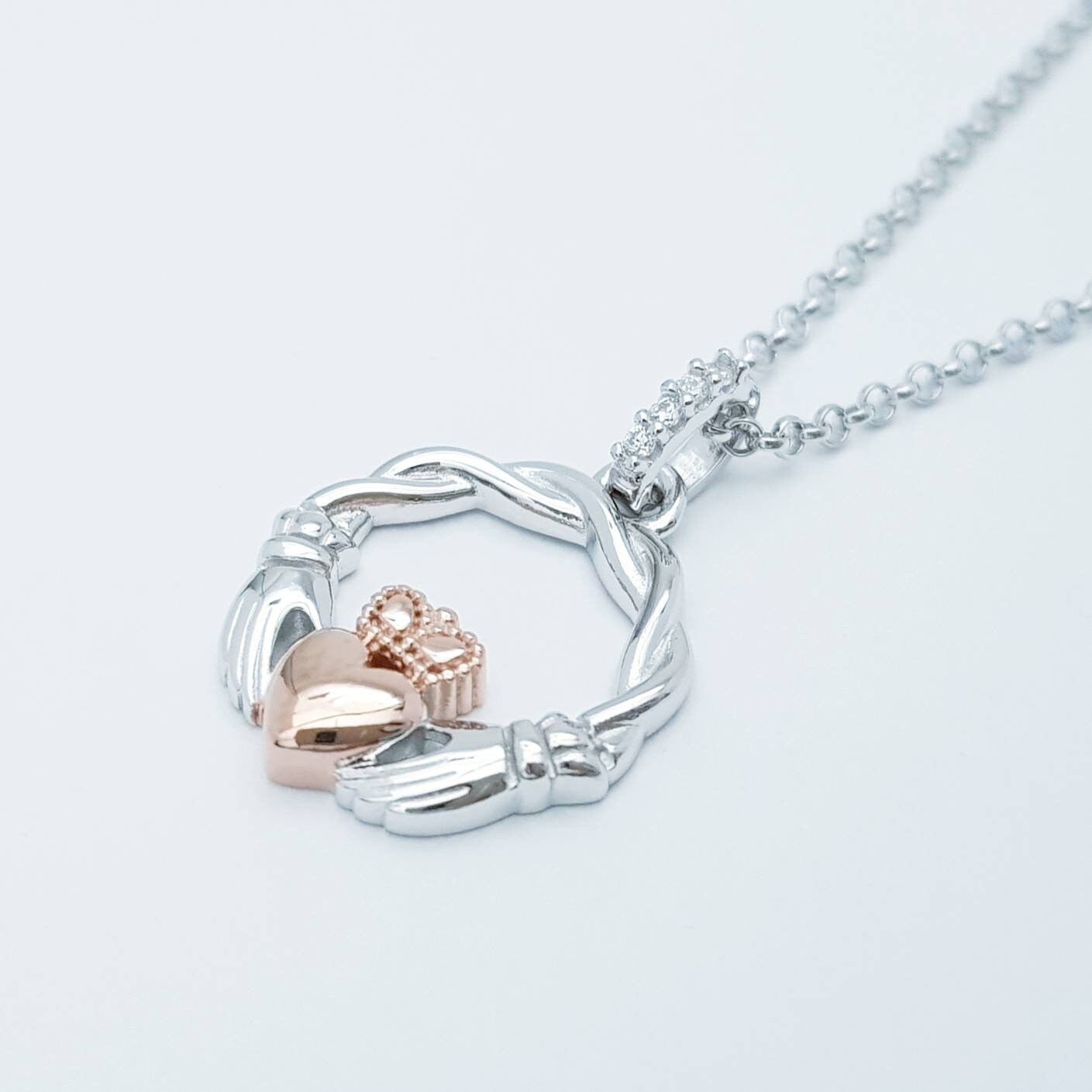 Dainty Sterling Silver claddagh necklace with rose gold plating and intertwined celtic braid.