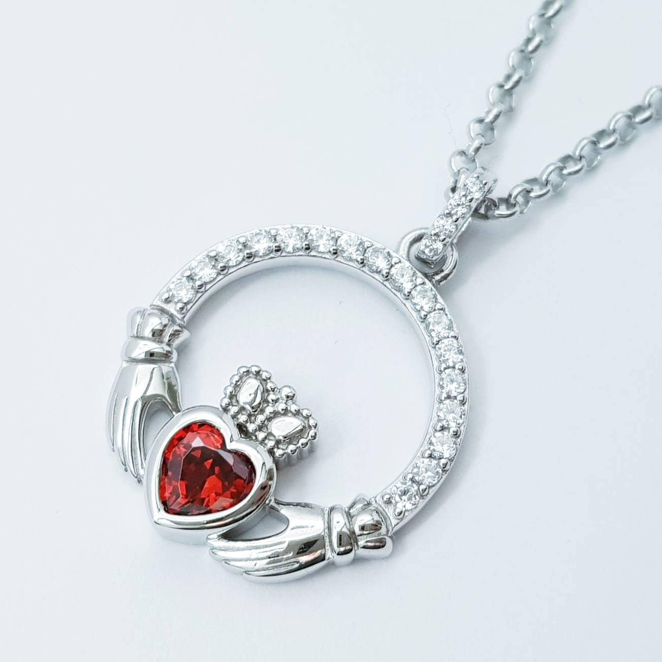 Sterling silver claddagh necklace  with red garnet heart shaped stone, January birthstone