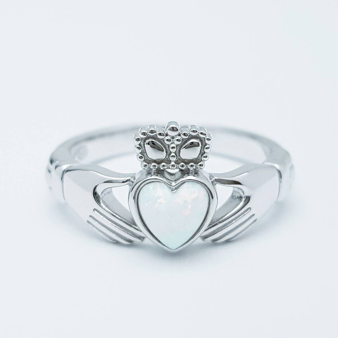 Sterling Silver Claddagh ring set with white opal heart, October birthstone