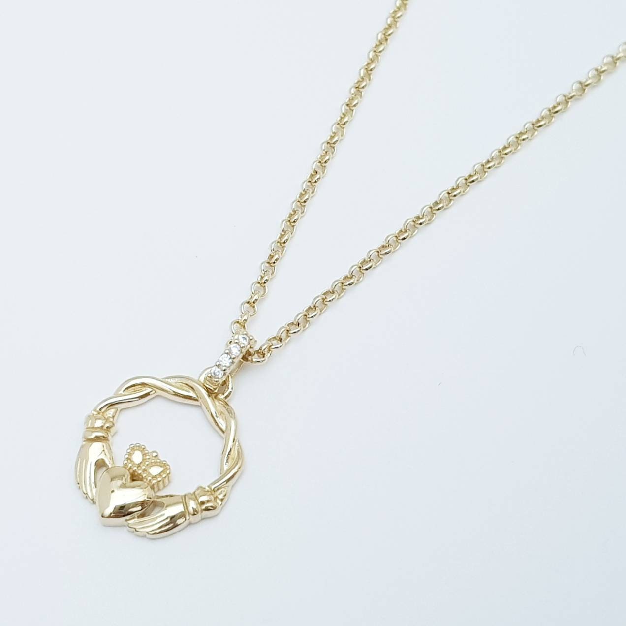 Dainty Sterling Silver claddagh necklace with gold plating and intertwined celtic braid.